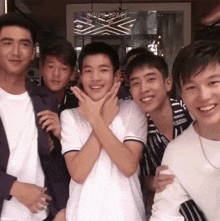 a group of young men are posing for a photo in front of a sign that says ' busy space '