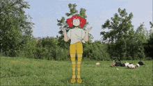 a cartoon girl with red hair is standing in the grass
