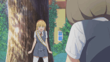 a girl with a sash that says ' a ' on it stands next to another girl