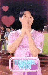 a man wearing a pink shirt that says ' united ' on it