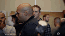 a group of men are gathered in a room with the hashtag #chicagofire on the bottom