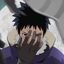 a man with a purple eye is covering his face with his hands
