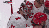 a hockey player wearing a helmet that says lenova on it