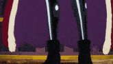 a cartoon character is holding a sword and wearing a purple cape