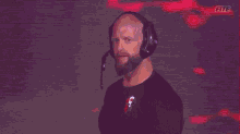 a man wearing headphones and a shirt that says f on it