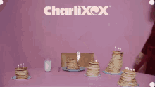 a man in a red robe is surrounded by stacks of pancakes
