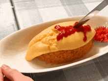 a plate of food with ketchup on it and a knife in it