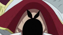 a close up of a person 's face with a red and white cape
