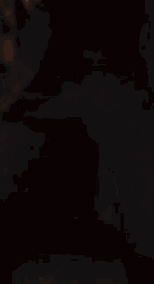 a blurred image of a person standing in the dark