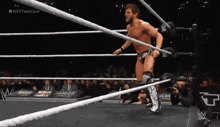 a man in a wrestling ring with the word nxt on the bottom