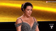 a woman in a very tight dress is sitting in front of a yellow background