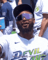 a man wearing a devils jersey and sunglasses says very hot very hot very hot