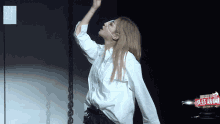 a woman in a white shirt with snh48 on the bottom right