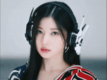 a woman wearing a pair of headphones that look like wings