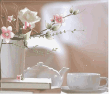 a cup of coffee sits on a saucer next to a book and a teapot