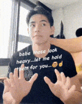 a man is making a funny face while holding his hands up in front of him .
