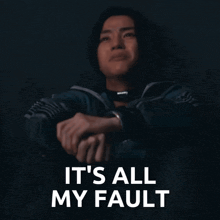 a man sitting down with the words " it 's all my fault " written above him