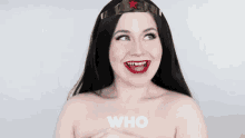 a naked woman in a wonder woman costume is smiling and looking up .
