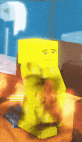 a yellow block with a sad face is sitting on a table