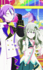 a boy and a girl are standing next to each other in front of a colorful background .