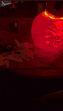 a red lantern with chinese writing on it is lit up in the dark