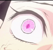 a close up of a person 's eye with a pink circle in it .