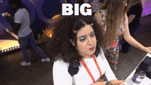 a woman sitting at a desk with the word big written above her