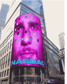 a large screen displays a man 's face and the word nasdaq