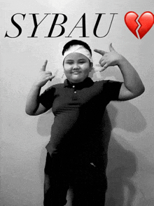a boy with a bandage on his head stands in front of a wall that says sybau and a broken heart