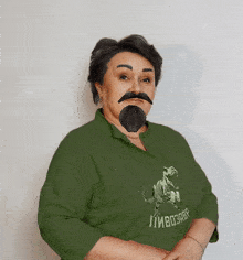 a woman with a fake beard and mustache is wearing a green shirt that says пивоварр