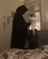 a silhouette of a grim reaper holding a wand