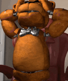 a brown teddy bear wearing a bow tie is standing in a room