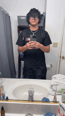 a man taking a picture of himself in a bathroom