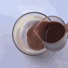 a person is pouring chocolate into a glass bowl which says mr.cakes on it
