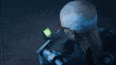 a man wearing glasses is looking at a green light
