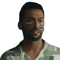 a man with a beard and green paint on his face is wearing a green and white shirt