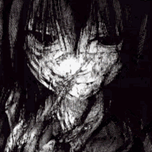 a black and white image of a person covering their face with their hands