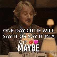 a man sitting at a table with the words one day cutie will say it or say it in a gif maybe on the bottom