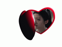 two red heart shaped mirrors with a man and a woman on them