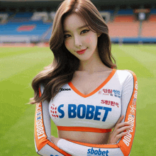 a woman wearing a s bobet crop top stands on a field