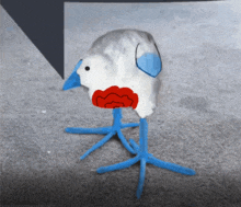 a drawing of a bird with blue feet and a red heart in its beak