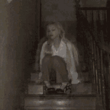 a woman with long blonde hair is wearing a white shirt and a white bra .