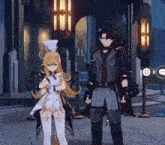 a man and a woman are standing next to each other in front of a building