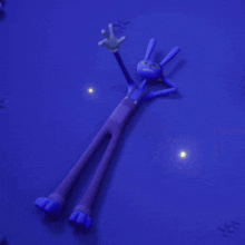 a cartoon rabbit is laying on the ground in the dark .