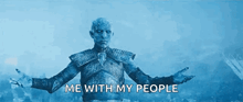 a man in armor is standing in front of a crowd with his arms outstretched and the words `` me with my people '' .