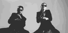 a man and a woman are dancing together in a black and white photo