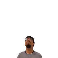 a man with glasses and a beard looks up at a green cross on his head