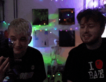 a man wearing a black t-shirt that says i love bae