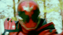 a close up of a person wearing a red helmet and gloves