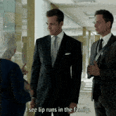 a man in a suit says " i see lip runs in the family " in a hallway